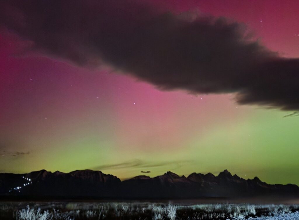 Northern lights over a mountain landscape symbolizing last minute holiday marketing ideas for small businesses preparing for the final holiday season push