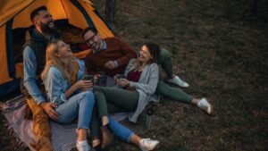 Flexible marketing solutions for small businesses represented by a team collaborating around a campfire roasting marshmallows