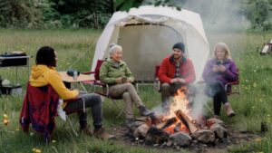 Flexible marketing solutions for small businesses represented by a team collaborating around a campfire roasting marshmallows